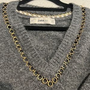 Zara V-neck sweater with gold trimming